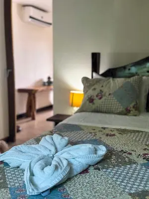 a towel laying on a bed in a bedroom at Cocobolo Beach Boutique Hotel in San Juanillo