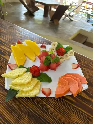 a plate of different types of fruit on a table at Cocobolo Beach Boutique Hotel in San Juanillo