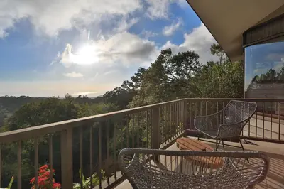 a balcony with a bench and a chair on a deck at Senda Monteverde Hotel Member of the Cayuga Collection in Monteverde Costa Rica