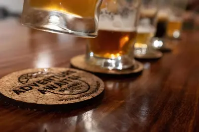 a coaster on a table with a glass of beer at Senda Monteverde Hotel Member of the Cayuga Collection in Monteverde Costa Rica