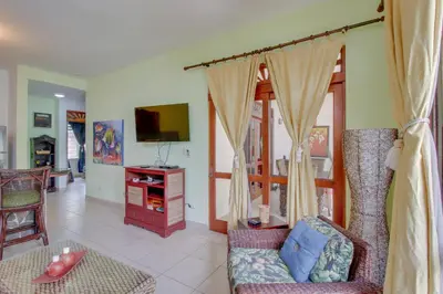 a living room with a couch and a tv at Bahia Azul 7A in Jacó