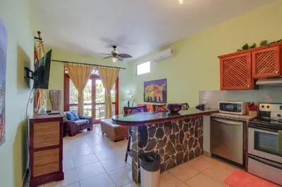 a kitchen and living room with a counter top at Bahia Azul 7A in Jacó