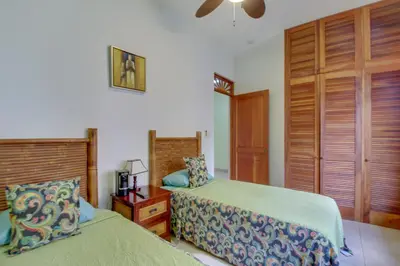 a bedroom with two beds and a ceiling fan at Bahia Azul 7A in Jacó