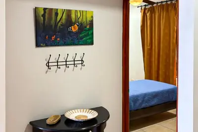 a room with a mirror and a table at La Paloma Blanca B3 in Jacó