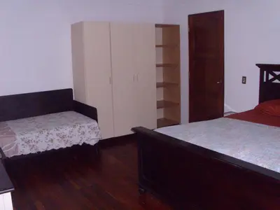 a bedroom with two beds and a dresser in it at Condominio Villa Hermosa in Playa Hermosa