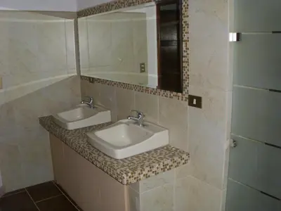 a bathroom with two sinks and a mirror at Condominio Villa Hermosa in Playa Hermosa