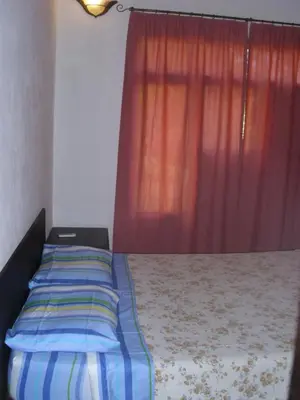a bedroom with a bed with a red curtain at Condominio Villa Hermosa in Playa Hermosa