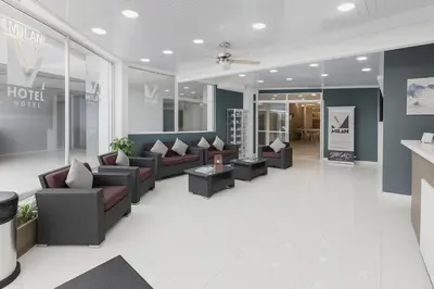 a lobby with couches and chairs in a store at Hotel Milan Costa Rica in San José