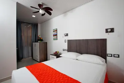 a bedroom with a bed and a ceiling fan at Hotel Milan Costa Rica in San José