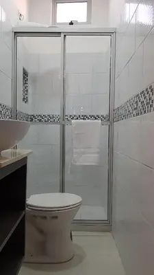 a bathroom with a shower with a toilet and a sink at Hotel Milan Costa Rica in San José