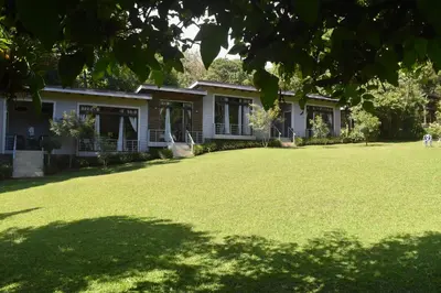 a house with a large lawn in front of it at YerbaBuena Lodge in Monteverde Costa Rica