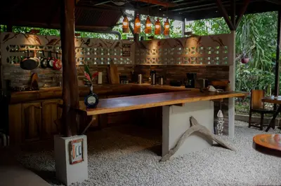 a bar in a restaurant with a wooden table at Samara Chillout Lodge - Adults only in Sámara