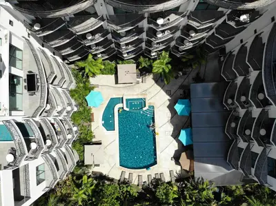 an overhead view of a swimming pool in a building at PACIFIC SUITES Boutique Hotel and Bistro in Jacó
