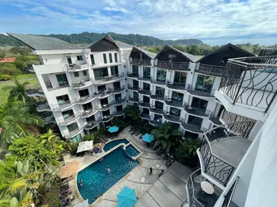 an aerial view of an apartment complex with a swimming pool at PACIFIC SUITES Boutique Hotel and Bistro in Jacó