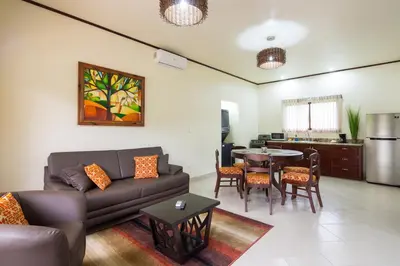 a living room with a couch and a table at Arenal Volcano Inn in Fortuna