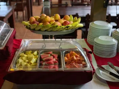 a tray of fruit on a table with a plate of fruit at Arenal Volcano Inn in Fortuna