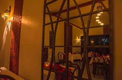 a mirror in a dining room with a table in front of it at Arenal Volcano Inn in Fortuna