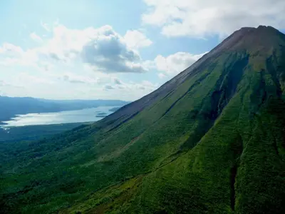 an aerial view of a mountain with a lake at Arenal Volcano Inn in Fortuna