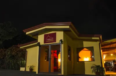 a small building with a sign on it at night at Arenal Volcano Inn in Fortuna
