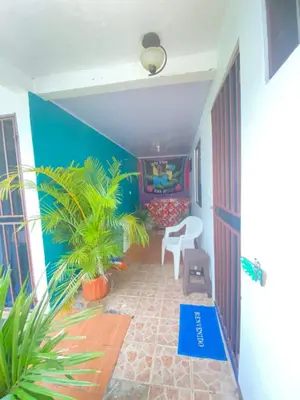 a hallway of a house with a table and a chair at Nomada's Digital in Manuel Antonio