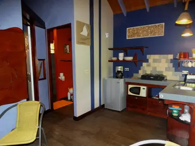 a small kitchen with a sink and a refrigerator at Dos Casitas in Ojochal