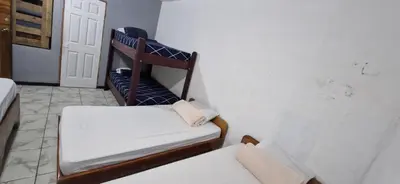 a small room with a chair and a bed at Mi Casa Tica in Monteverde Costa Rica