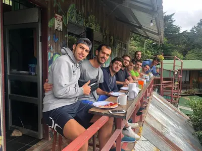 a group of men sitting at a table at Mi Casa Tica in Monteverde Costa Rica
