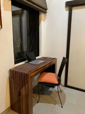 a desk with a laptop and a chair next to a window at Villas Lambeau Ocean View 1 in Uvita