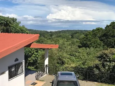 a car parked outside of a house with a view at Villas Lambeau Ocean View 1 in Uvita