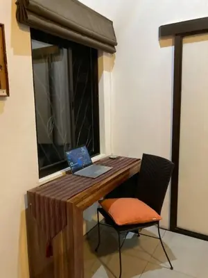 a wooden desk with a laptop and a chair at Villas Lambeau Ocean View 1 in Uvita