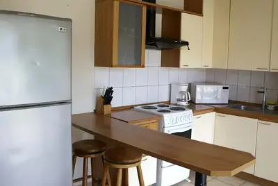 a kitchen with a stove and a counter with stools at BL10 Bahia Langosta On the Beach 1bed+1bath in Tamarindo