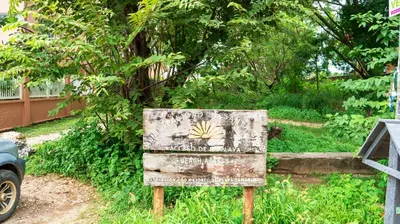 a sign in the grass next to a car at BL10 Bahia Langosta On the Beach 1bed+1bath in Tamarindo