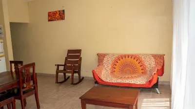 a living room with a couch and some chairs at LC4 La Cometa Center of Tamarindo 1bed+1bath in Tamarindo