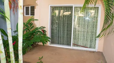 a sliding glass door with a window with plants at LC4 La Cometa Center of Tamarindo 1bed+1bath in Tamarindo