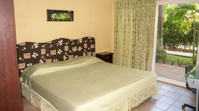 a bedroom with a bed and a large window at LC4 La Cometa Center of Tamarindo 1bed+1bath in Tamarindo