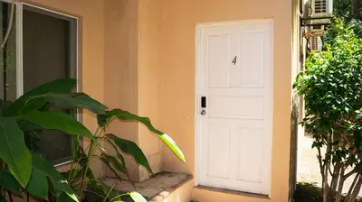 a white door on the side of a house at LC4 La Cometa Center of Tamarindo 1bed+1bath in Tamarindo