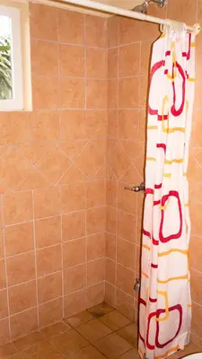 a shower with a shower curtain in a bathroom at LC18 Cometa18 Center of Tamarindo 2bed 3bath in Tamarindo