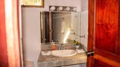a bathroom with a sink and a mirror at CWC Casa Wasabi 1bedroom 1bathroom in Tamarindo