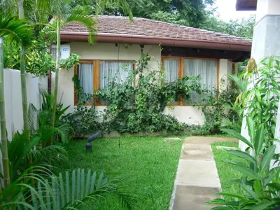 a garden in front of a house at CWC Casa Wasabi 1bedroom 1bathroom in Tamarindo