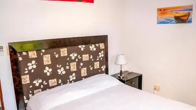 a bedroom with a bed with a floral head board at CWC Casa Wasabi 1bedroom 1bathroom in Tamarindo