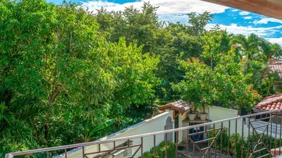 a view of trees from a balcony of a house at CW2 Casa Wasabi 2bed+1bath in Tamarindo