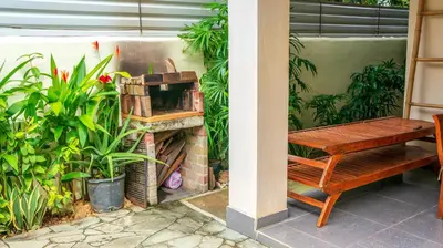 a bench sitting next to a wall with plants at CW3 Casa Wasabi 3bed+3bath in Tamarindo