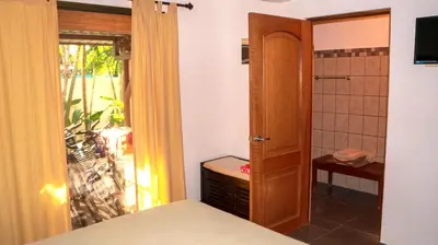 a bedroom with a door leading to a balcony at CW3 Casa Wasabi 3bed+3bath in Tamarindo