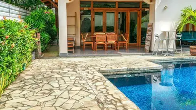a house with a swimming pool and a table and chairs at CW3 Casa Wasabi 3bed+3bath in Tamarindo