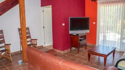 a living room with a couch and a tv at LC17 La Cometa Center of Tamarindo 2bed+2.5bath in Tamarindo
