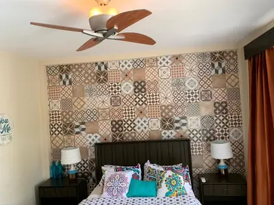a bedroom with a ceiling fan and a bed with pillows at Hotel Las Palmas de OSA in Ciudad Cortés