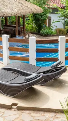 a swimming pool with a surfboard on top of it at Hotel Luna Llena in Tamarindo