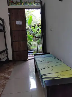 a bedroom with a bed and a door to a garden at Salamandra Costa Rica in Jiménez