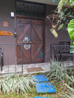 a dog standing at the door of a house at Salamandra Costa Rica in Jiménez