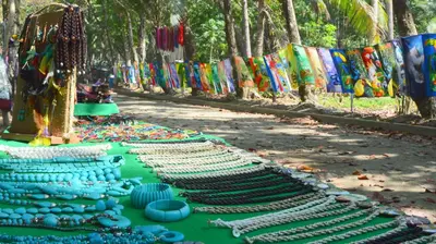 a row of blue and green glasses on a table at Hotel Villas Rio Mar in Dominical